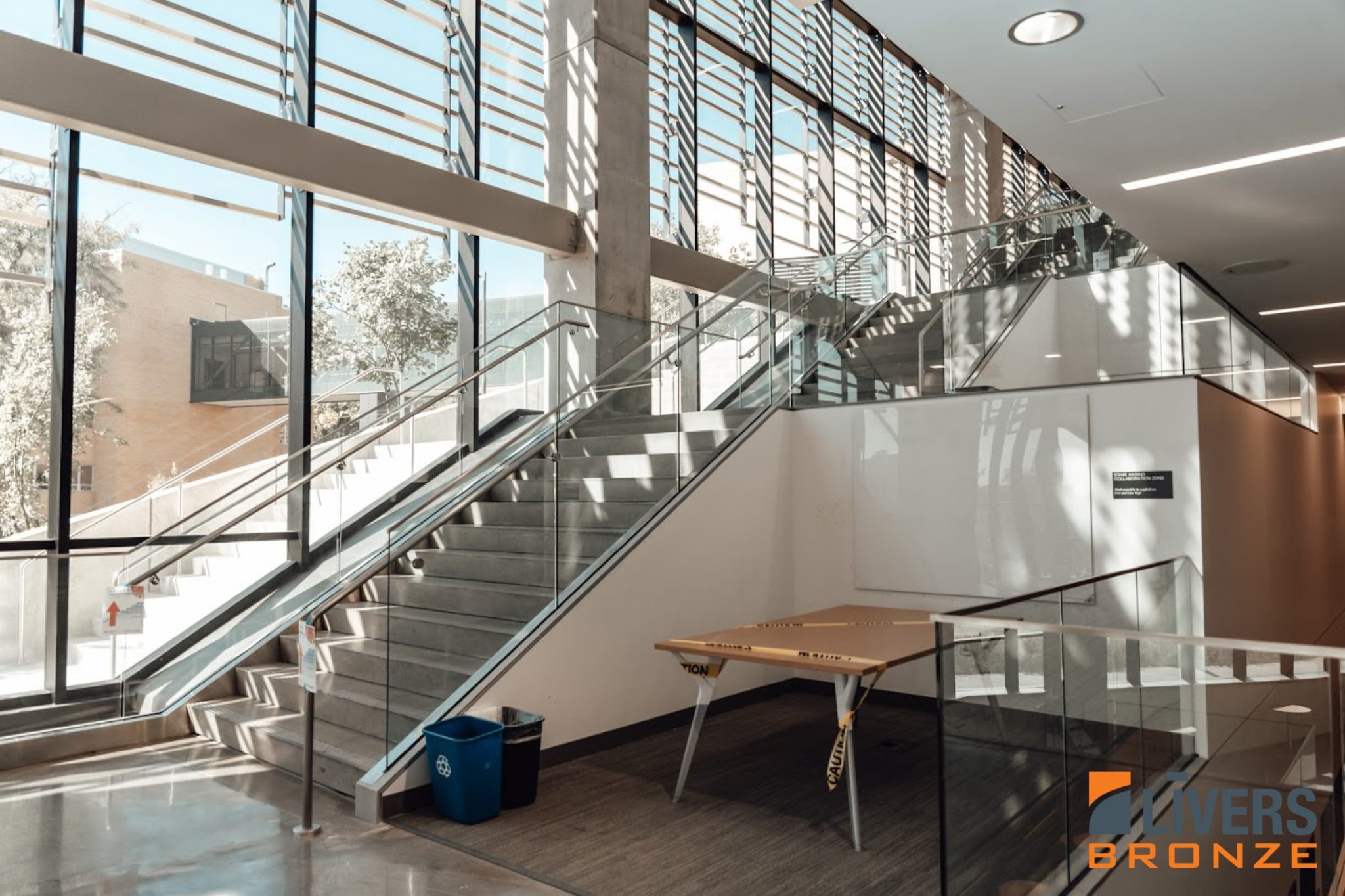 Livers Bronze Struct-U-Rail Commercial Glass Railing installed at Earth, Energy & Environment Center, University of Kansas Lobby Stairs Made in the USA