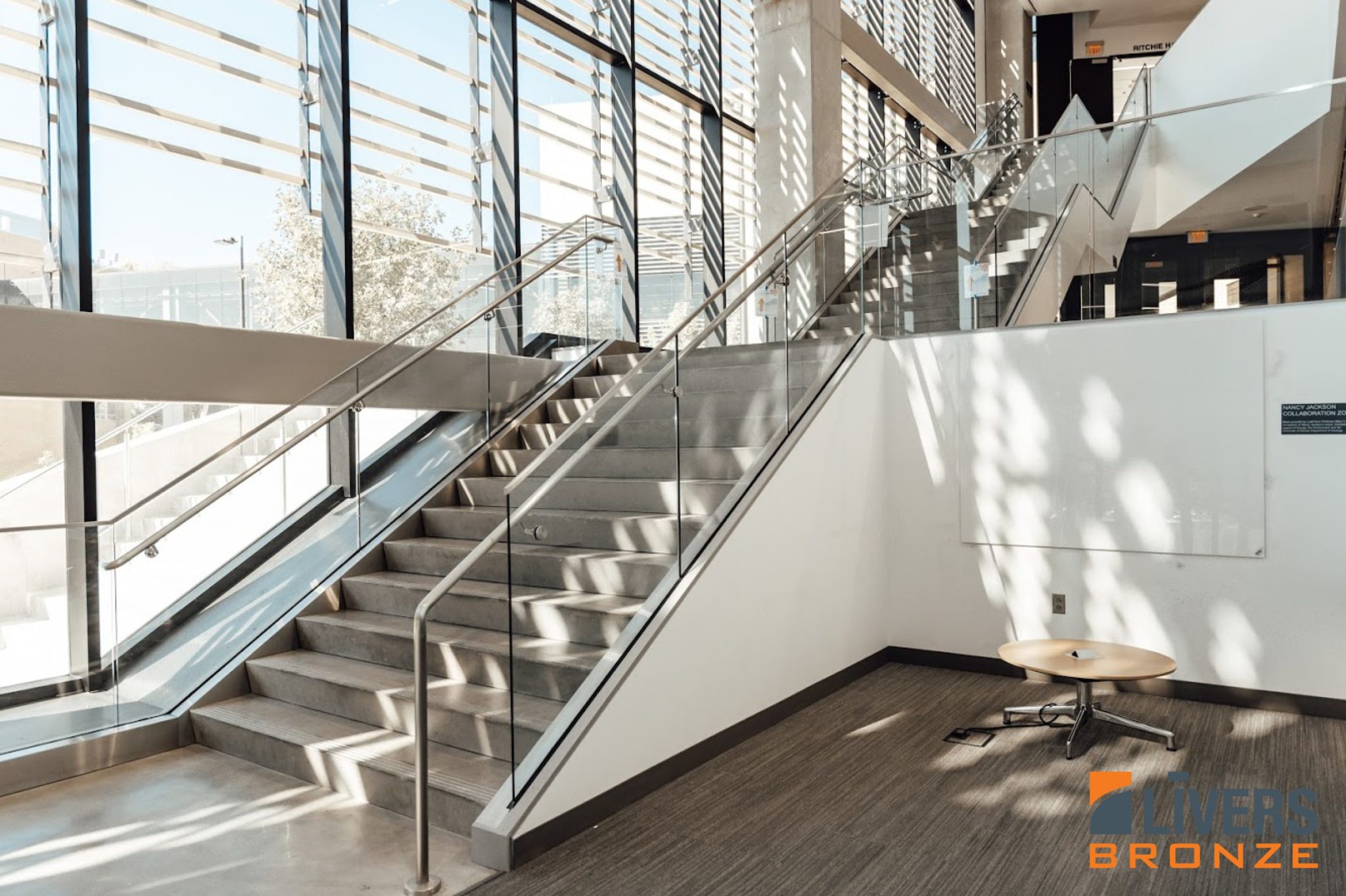 Livers Bronze Struct-U-Rail Commercial Glass Railing installed at Earth, Energy & Environment Center, University of Kansas Lobby Stairs Made in the USA