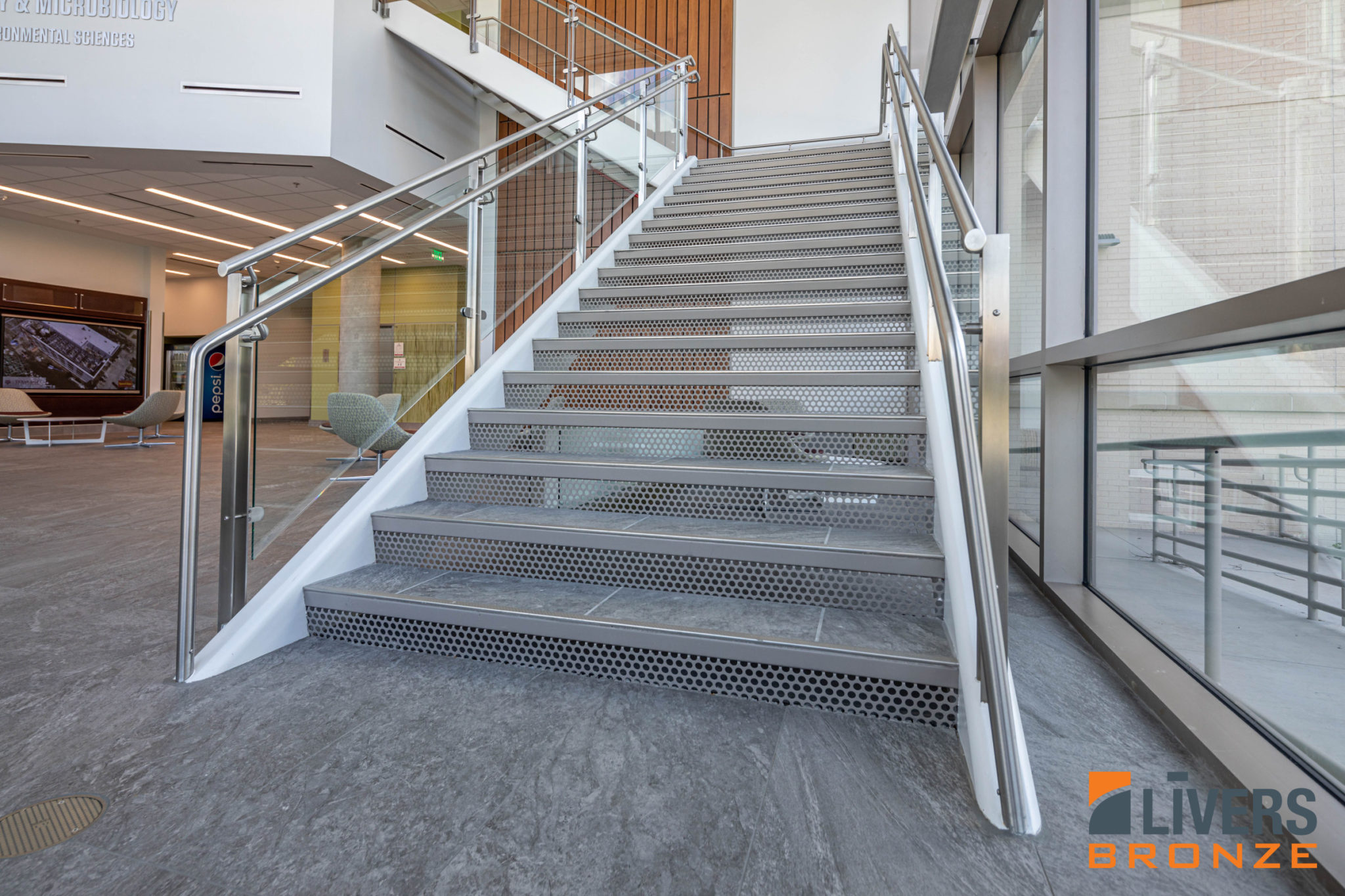 Livers Bronze Icon Glass Railings with laminated glass and Stainless Steel Railings were installed at the Lobby Stairs and Interior Balcony at the Student Library at Texas A&M University's Plant Pathology and Microbiology Building and were made in the USA.