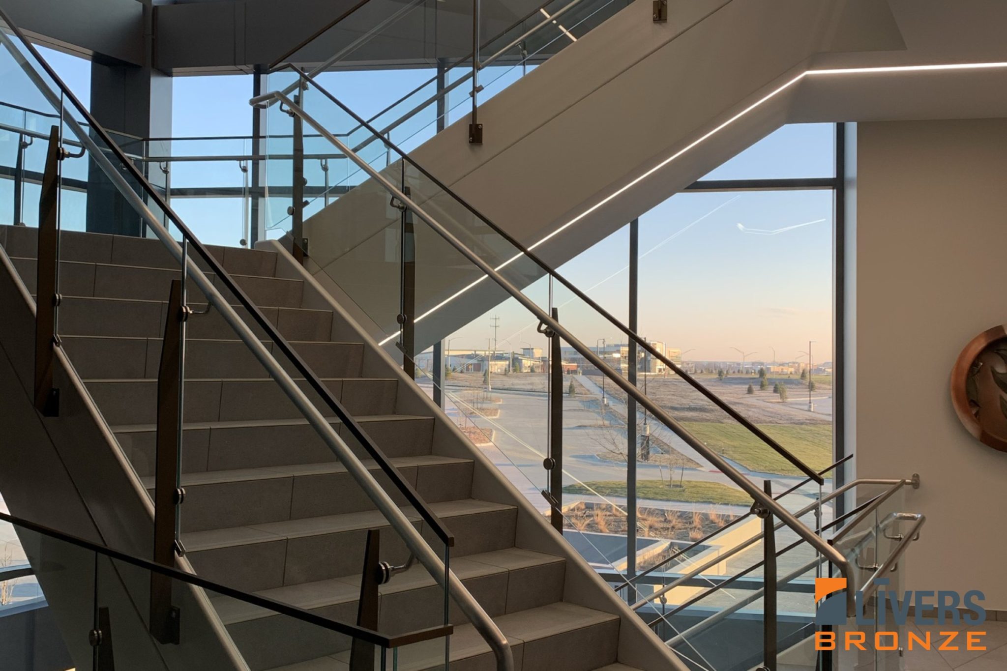 Livers Bronze Belmont Stainless Steel Railings with Powder Coated Railing Posts were installed at the office lobby stairs at Sammons Financial Headquarters, Des Moines, Iowa, and were Made in the USA.