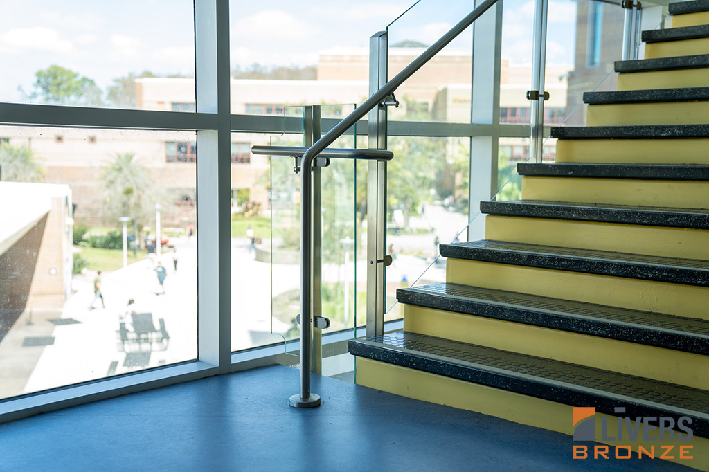 Livers Bronze Icon Glass Railings with laminated glass and Stainless Steel Railings were installed at the Lobby Stairs at the Student Library at the University of Central Florida and were made in the USA.