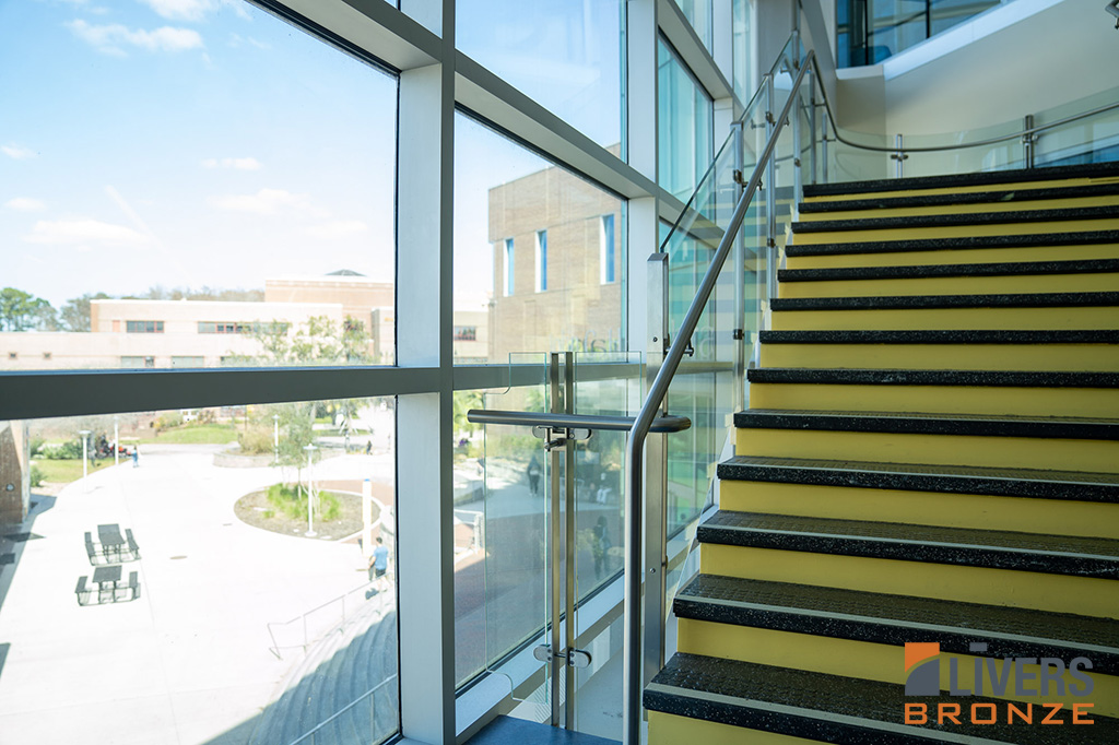 Livers Bronze Icon Glass Railings with laminated glass and Stainless Steel Railings were installed at the Lobby Stairs at the Student Library at the University of Central Florida and were made in the USA..