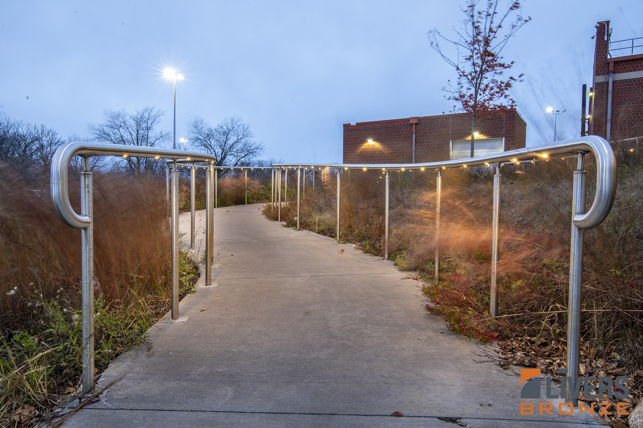 Livers Bronze Illume Puck LED curved railings were installed along the exterior pedestrian ramp at MidAmerican Energy Headquarters, Urbandale, Iowa, and were Made in the USA.