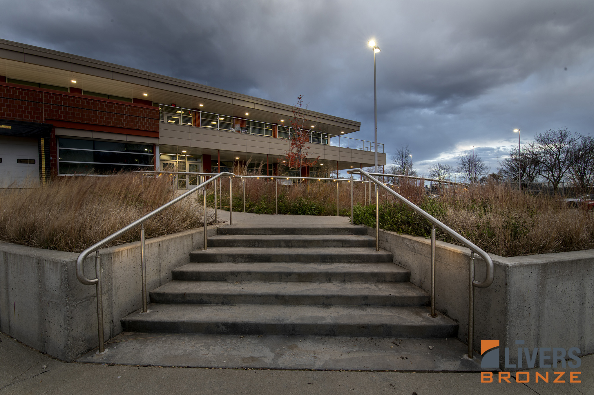 Livers Bronze Illume Puck LED curved railings were installed along the exterior pedestrian ramp at MidAmerican Energy Headquarters, Urbandale, Iowa, and were Made in the USA..