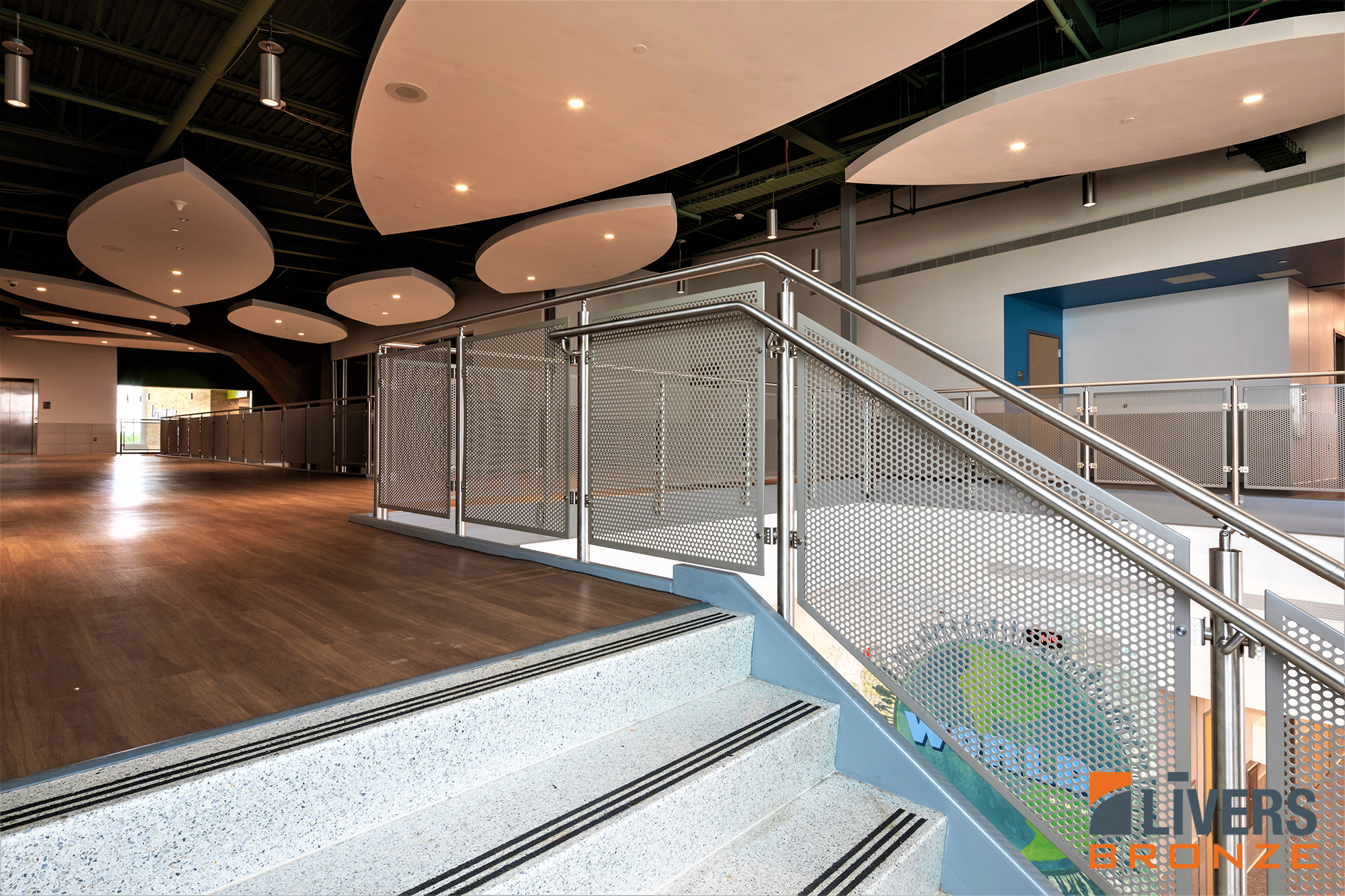 Livers Bronze Mirage Stainless Steel Railings with Decorative Perforated Panels were installed at the interior stairways and balconies at Red Bud Elementary School, Austin, Texas, and were Made in the USA