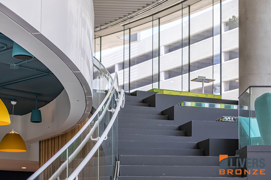Livers Bronze Struct-U-Rail Commercial Glass Railing System with laminated glass was installed at an office lobby stairway and was Made in the USA.