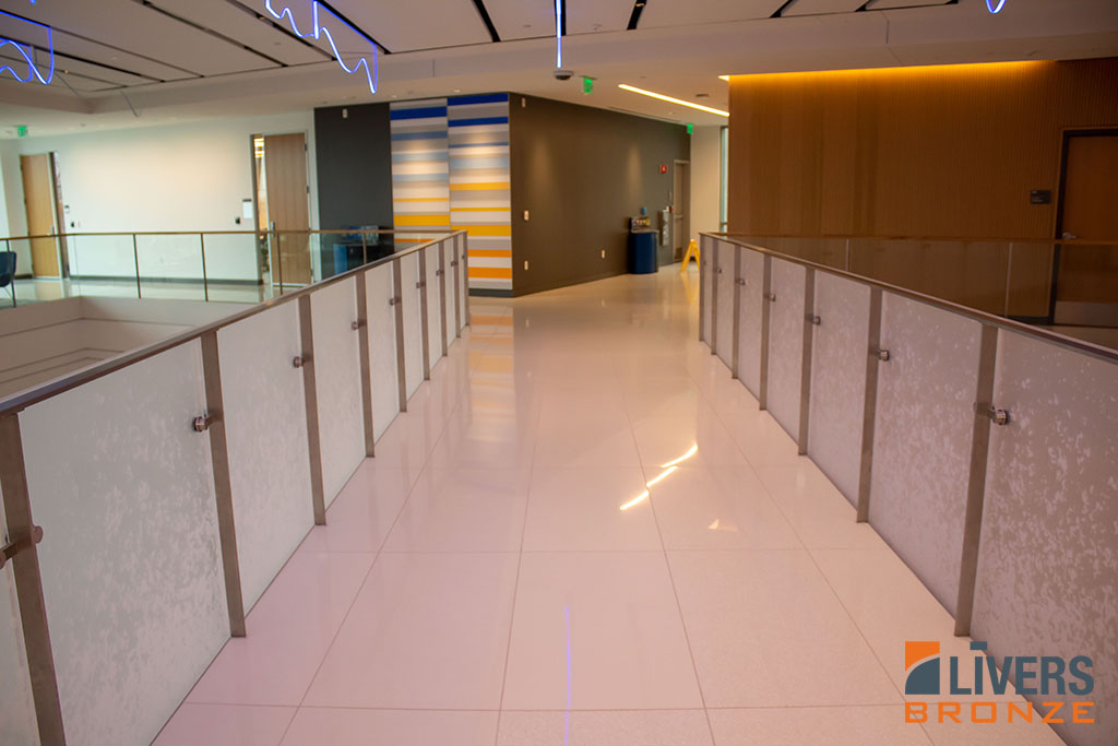 Livers Bronze Plank glass railings with custom acrylic panels were installed at the interior pedestrian bridge at Tufts University’s Joyce Cummings Center and were Made in the USA.