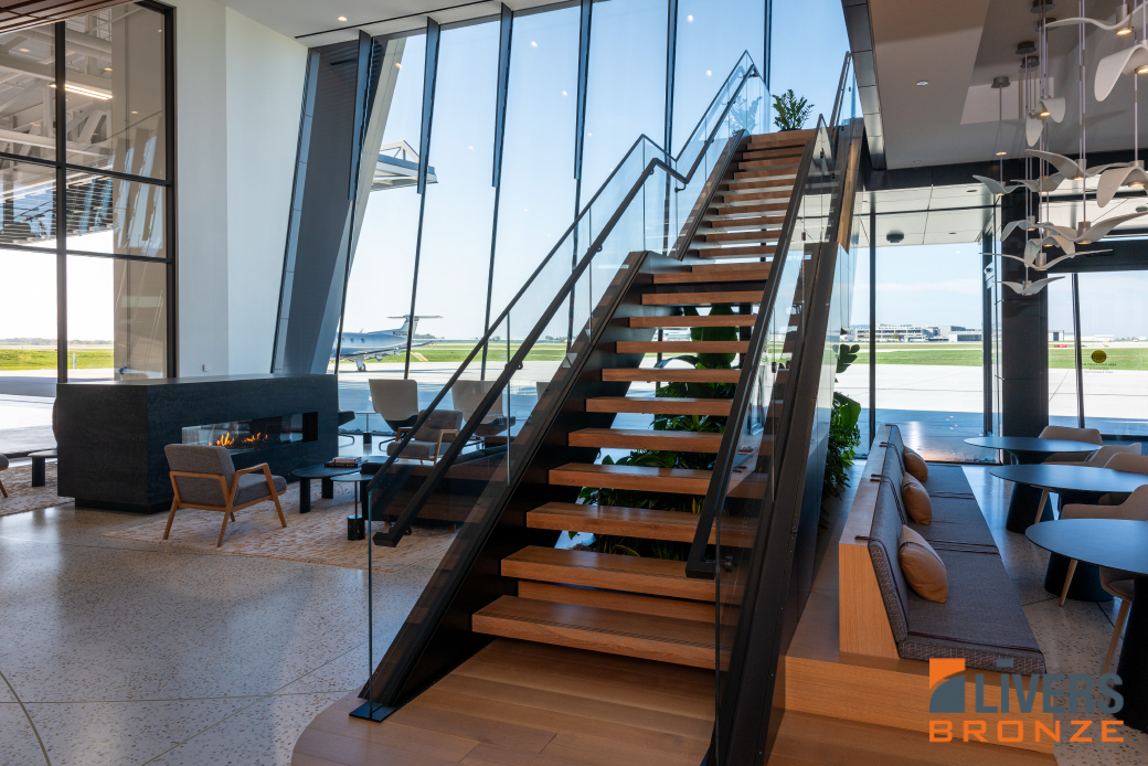 Livers Bronze glass railings were installed at the interior stairway and balcony and the exterior terrace at the Otter Air Services Passenger Lounge and were Made in the USA.